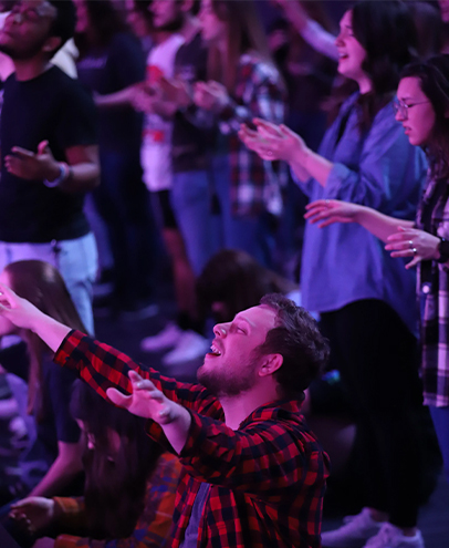 Young adults worshiping at Rhema Bible Church