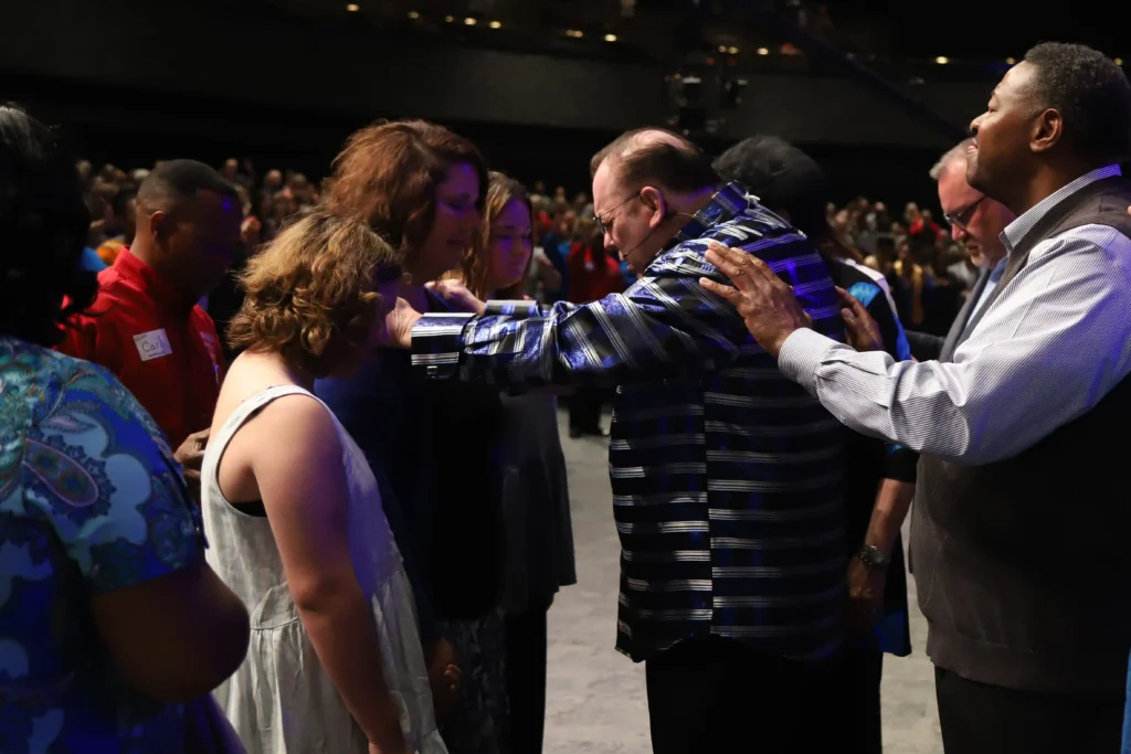 Leaders laying hands on people